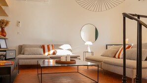 A modern living room with a sofa, coffee table, and a large mirror. - Saint-Tropez: Bright apartment near the port (Saint-Tropez)