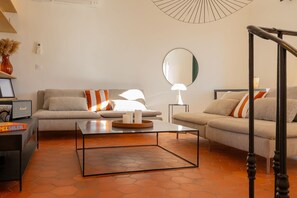 Una sala de estar moderna con un sofá, una mesa de centro y un espejo grande.