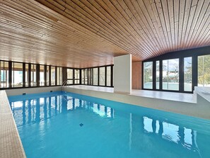 An indoor swimming pool with wooden ceiling and large windows. - Alpine Club Retreat - Central Studio, Pool & View (Crans-Montana)