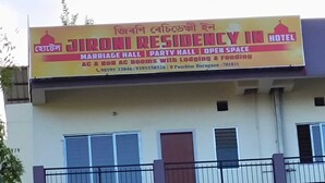 A signboard for Jironi Residency Inn Hotel advertising a marriage hall, party hall, and open space with AC and non-AC rooms, lodging, and food services. - Jironi Residency In (Guwahati)