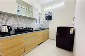 Fridge, stovetop, cookware/dishes/utensils, dining tables - 1BR Service apartment A -1503 Malad by Florastays (Mumbai)