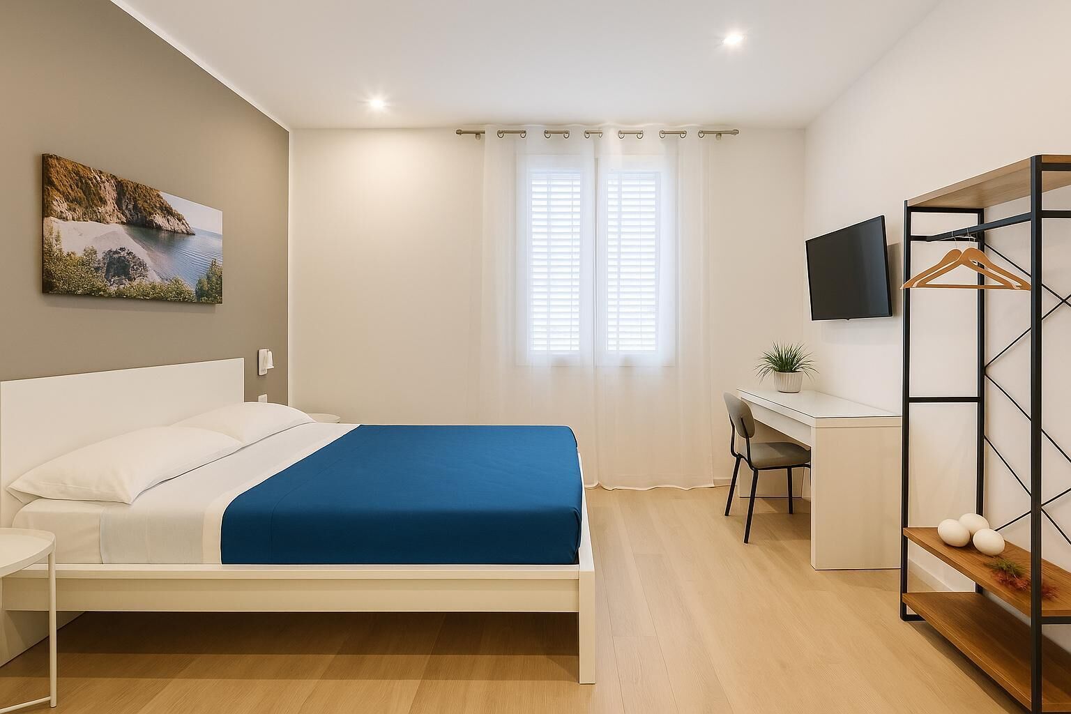 A bedroom with a bed, a desk, a chair, a TV, and a wardrobe.