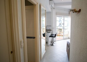 A hotel corridor with a bathroom, a salon, and a view of the outside. - Skol 205 A - Studio 1 Bedroom Apartment Skol building, west Sea Views (Marbella)