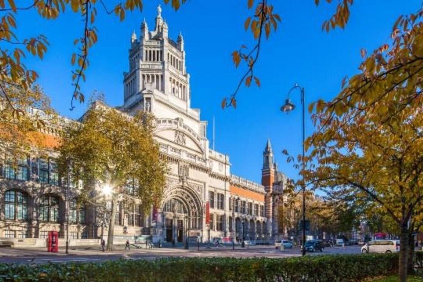 A historic building with a prominent tower, a large arched entrance, and a clock tower.