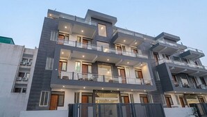 A multi-story residential building with balconies, large windows, and a modern architectural design. - COZY COVE (Dera Bassi)