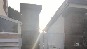 A gated entrance with a white gate, a brick wall, and a small utility box. - Les Studios de la Côte Roz: Voyageur Solo, (Perros-Guirec)