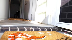 A doormat with a lion design and the word "HOWES" on a residential entrance. - THE QUARTERS #1 Centrally located modern 2 bed unit featuring stylish decor (East Tamworth)
