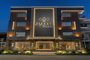A modern hotel facade with the name "Belle Tree" illuminated on the front. - Belle Tree Hotel (Greater Noida)