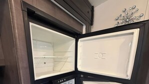 A kitchen with a built-in refrigerator, a microwave, and a stove.
