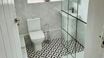Shower, hair dryer, towels, toilet paper
