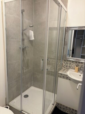 Shower, rainfall showerhead, towels, soap