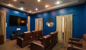 A home theater room with blue walls, a large flat-screen TV, and multiple leather recliner seats. - 1 BA Marina Del Rey - Quick Trip To Venice Beach (Marina del Rey)