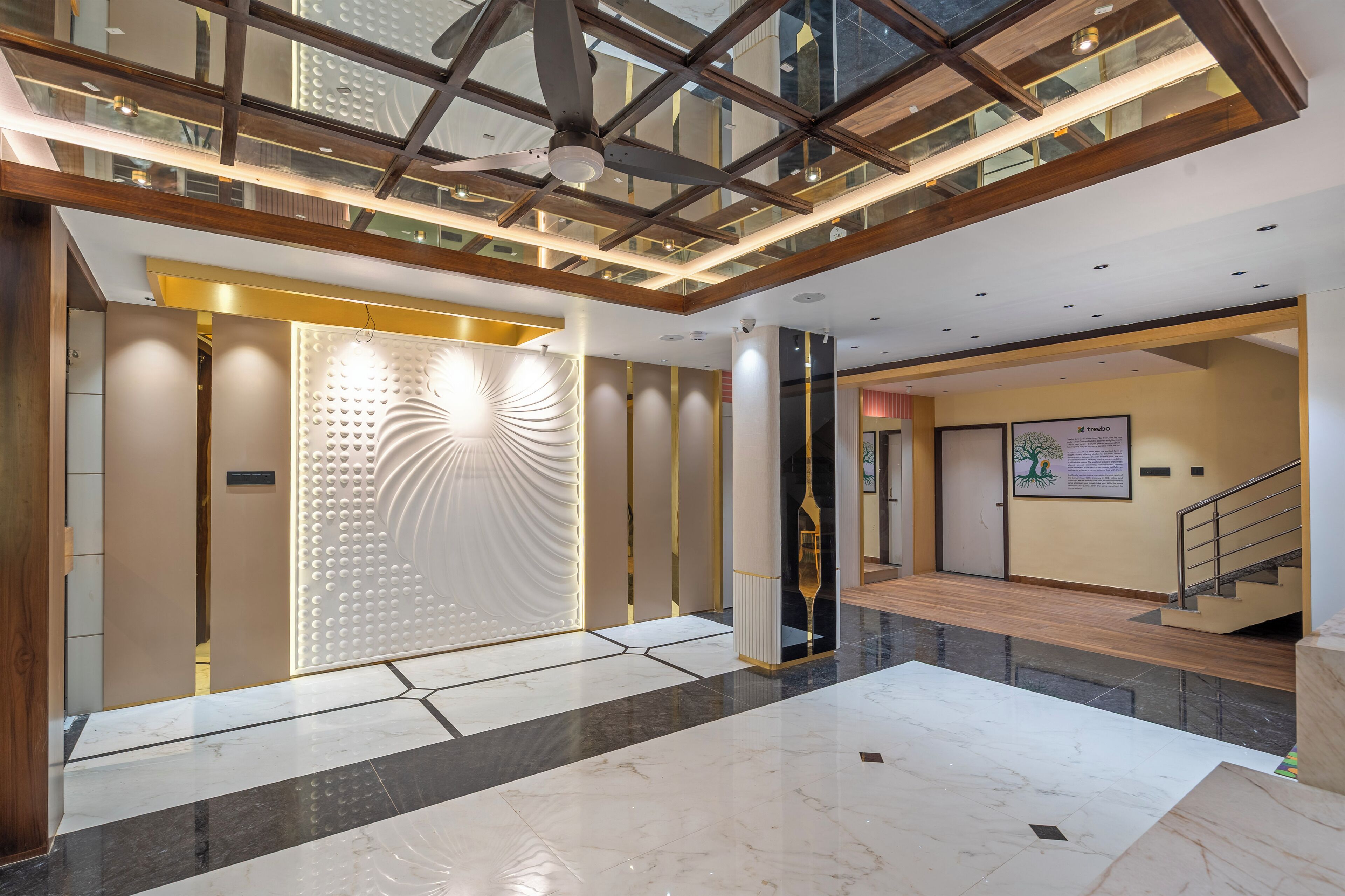 A spacious lobby with a high ceiling, a glass enclosure, and a modern design.