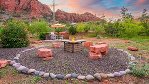 A patio area with a fire pit, outdoor furniture, and a view of red rock formations. - NEW Cimaron Butte Studio Laundry Kitchenette (Sedona)