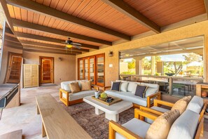 A spacious living area with a wooden ceiling, large windows, and a modern sofa set. - NEW 2M Luxe N Scottsdale Estate w Heated Pool (Scottsdale)