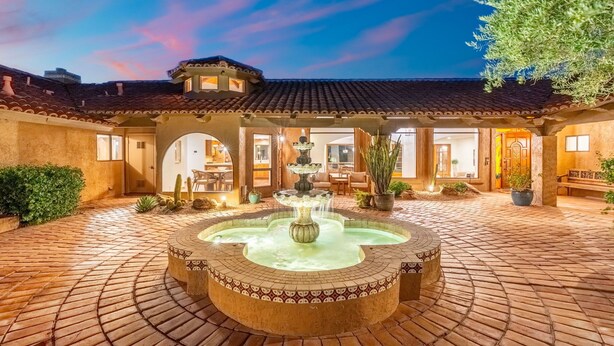 A courtyard with a central fountain, tiled flooring, and a building with arched doorways. - NEW 2M Luxe N Scottsdale Estate w Heated Pool (Scottsdale)