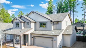 A two-story house with a garage, a covered patio, and a fenced yard. - NEW Alamo Alpine Retreat Sleeps 11 3 Showers (Flagstaff)