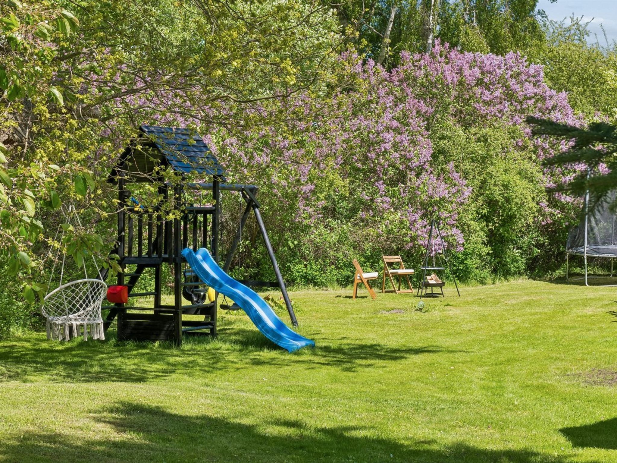 A playground with a slide, swings, and a climbing structure.
