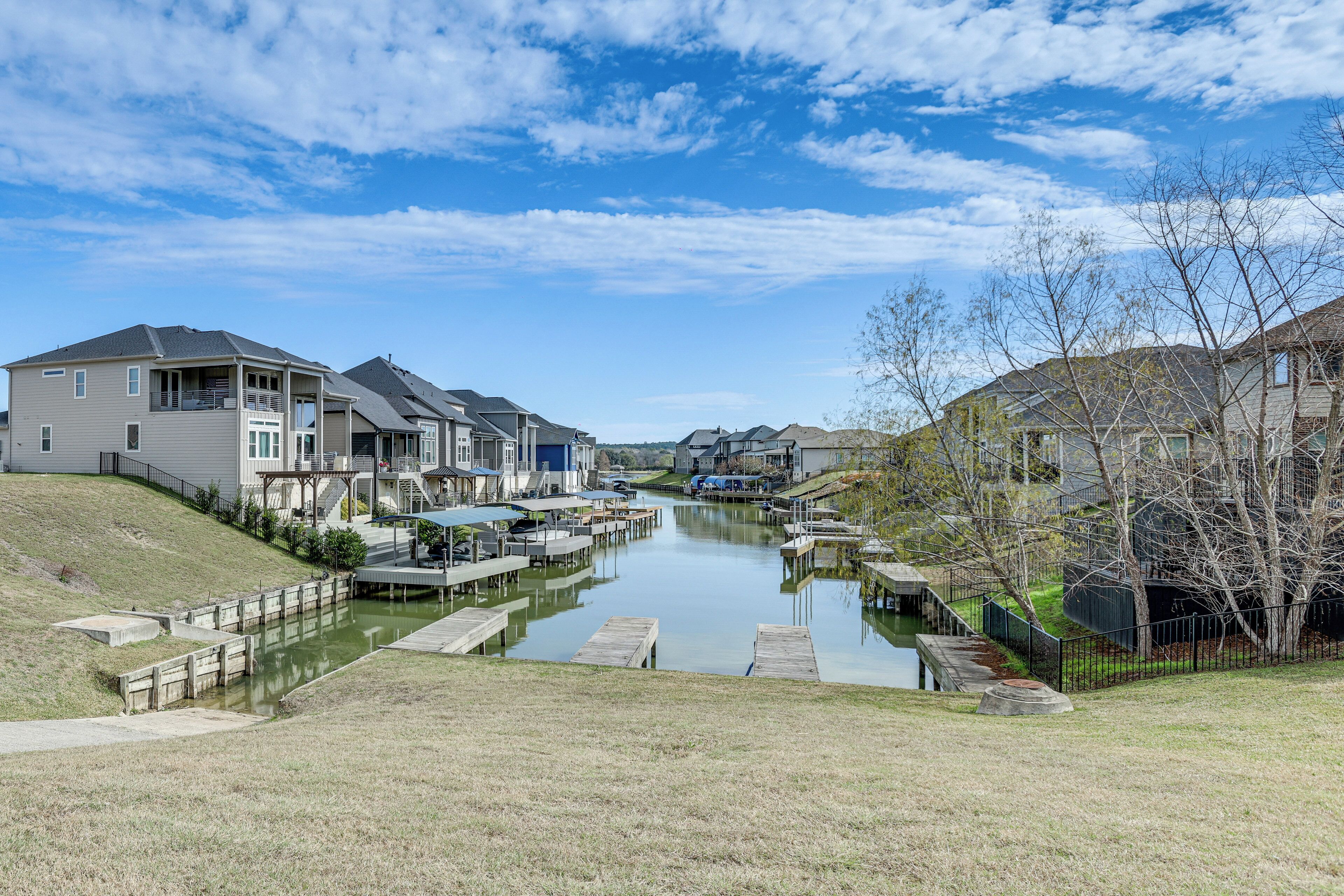 A residential area with houses, a canal, and docks.