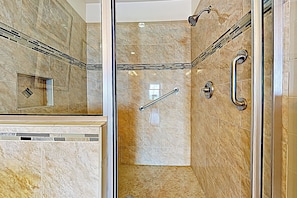 A modern bathroom with a glass-enclosed shower, marble tiles, and a handrail. - 2BR Penthouse Paradise w/ Front-row Gulf Views (South Padre Island)