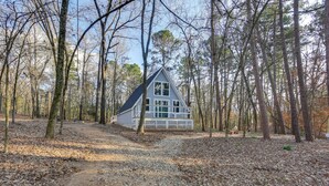 A cabin in a forest with a dirt path leading to it. - Romantic A-frame Retreat w/ Fire Pit + Hammocks (Hawkins)