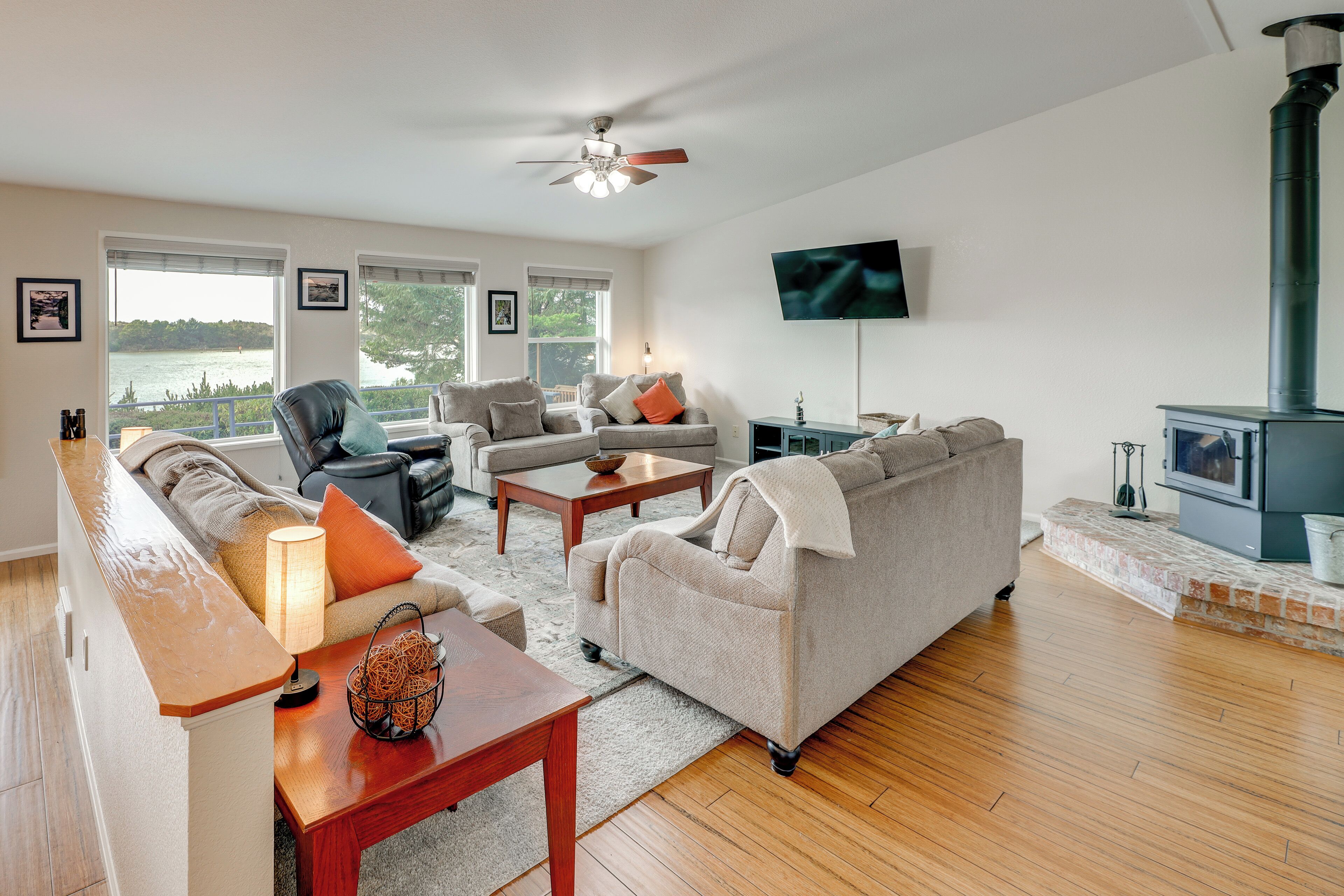 A living room with a sofa, armchairs, a coffee table, and a fireplace.