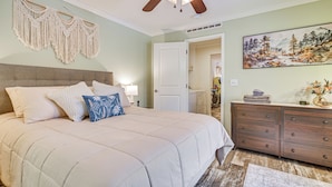 A bedroom with a large bed, a ceiling fan, a macrame wall hanging, a dresser, and a painting on the wall. - Near Trails & Vast Access! Modern Burke Home Base (East Burke)
