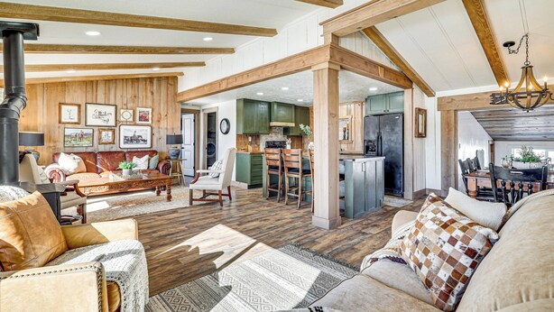 A spacious living area with a high ceiling, wooden beams, and a central fireplace. - 'luna Ranchhouse' Nestled Among the Pines! (Luna)