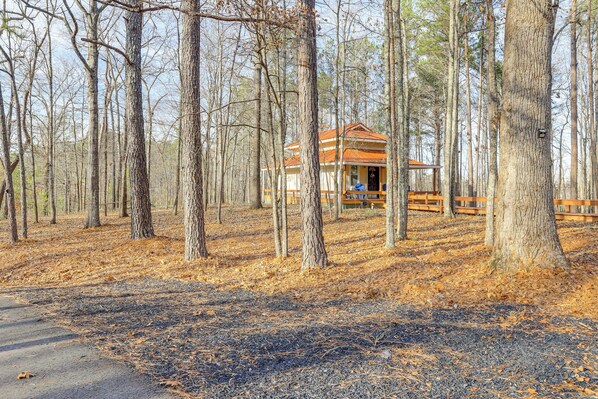 A rustic cabin surrounded by tall trees in a forest. - Forest-view Gem in Grantville w/ Wraparound Deck (Grantville)