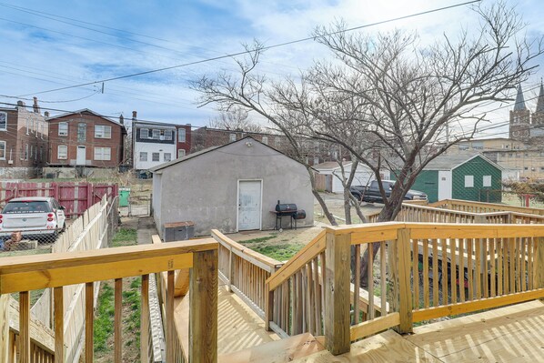 A residential area with a small shed, a wooden deck, and a brick house in the background. - Walk to Carondelet Park: Quiet Couple's Getaway (St. Louis)
