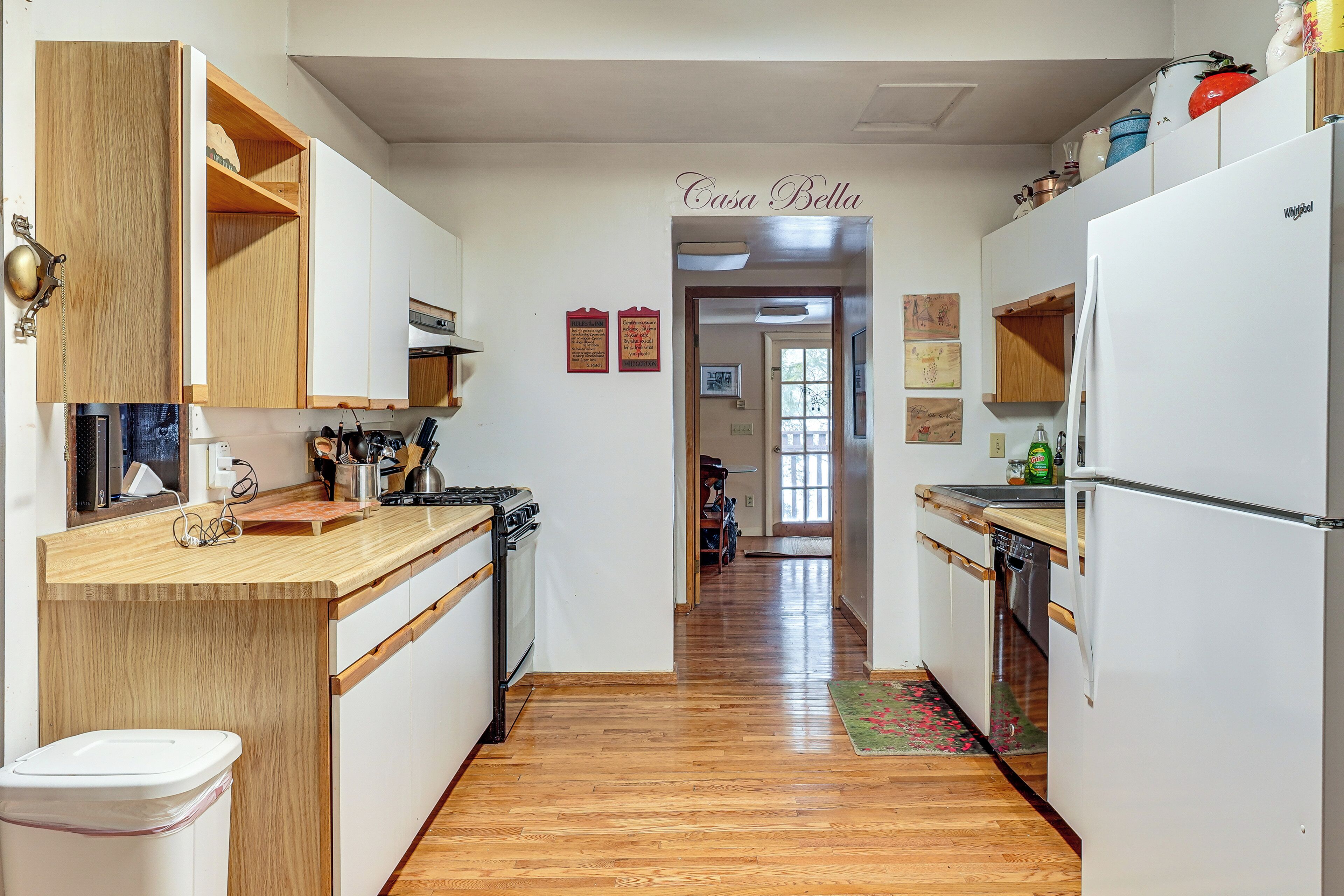 A kitchen with wooden cabinets, a stove, and a refrigerator.