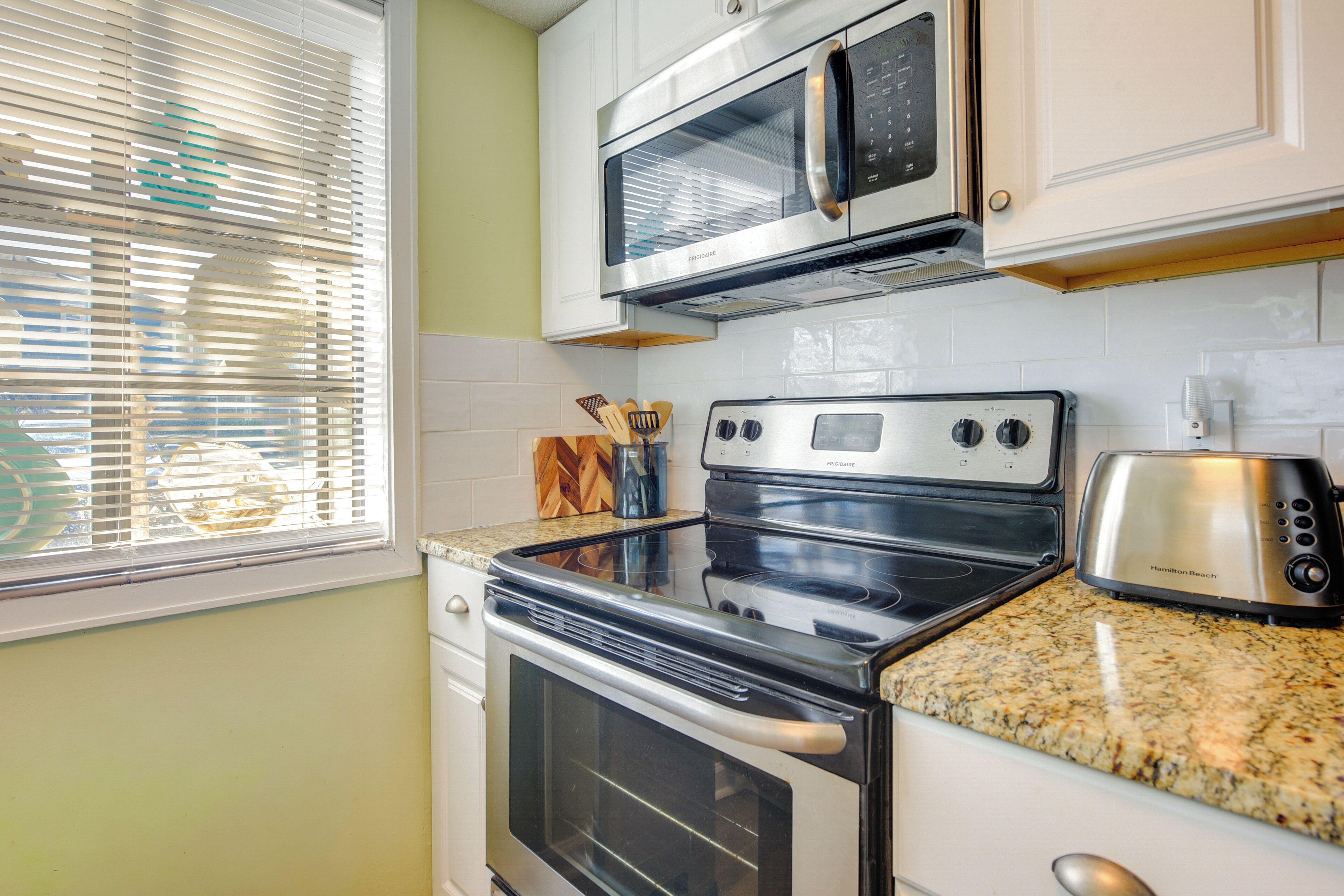 A kitchen with a double oven, a microwave, and a toaster.