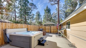 A backyard with a hot tub, wooden deck, and a house. - Hot Tub + Game Room: Group Getaway in Big Bear! (Sugarloaf)