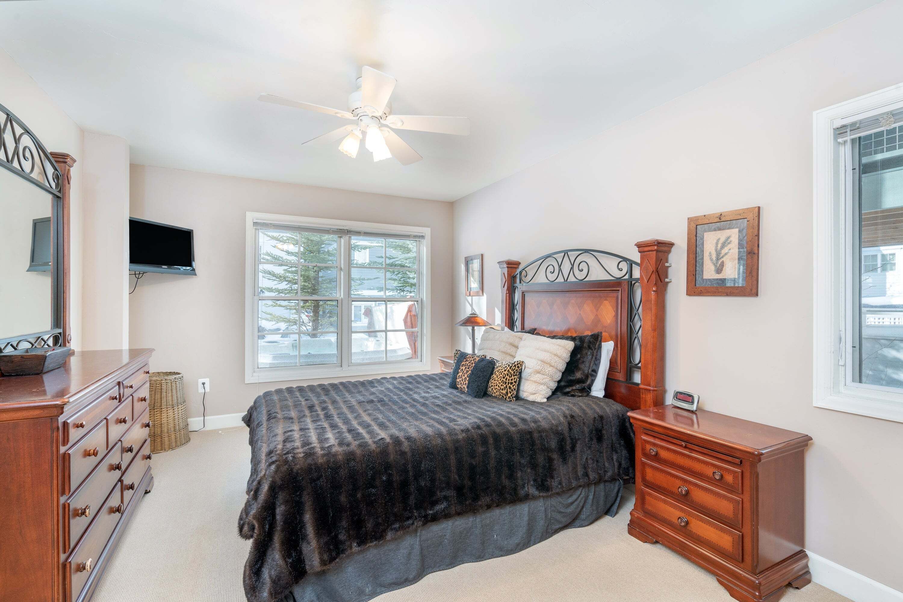 A bedroom with a bed, dresser, and nightstand.