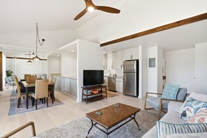A modern living room with a flat-screen TV, a coffee table, and a sofa. - Kihei Holiday, #315 2 Bedroom Condo (Kihei)