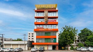 A multi-story hotel with a prominent sign for 'Hotel Royal Inn' and 'Hotel Sun Stay.' - Hotel Sun Stay Ahmedabad (Ahmedabad)