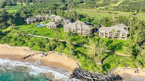 An aerial view of a resort with multiple buildings, a golf course, and a beach. - Kaha Lani 303- Oceanview Heavenly Place (Lihue)