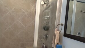 A bathroom with a shower, a sink, a mirror, and a towel rack. - Located in the heart of Ocean City,Downtown this spacious 4-bedroom apartment. (Ocean City)