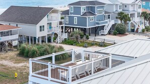 A coastal residential area with houses featuring balconies and a view of the ocean. - Ultimate Luxury 7-bedroom, 7+bathroom w/private pool &elevator, steps from the beach (Holden Beach)