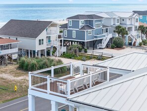 A coastal residential area with houses featuring balconies and a view of the ocean. - Ultimate Luxury 7-bedroom, 7+bathroom w/private pool &elevator, steps from the beach (Holden Beach)