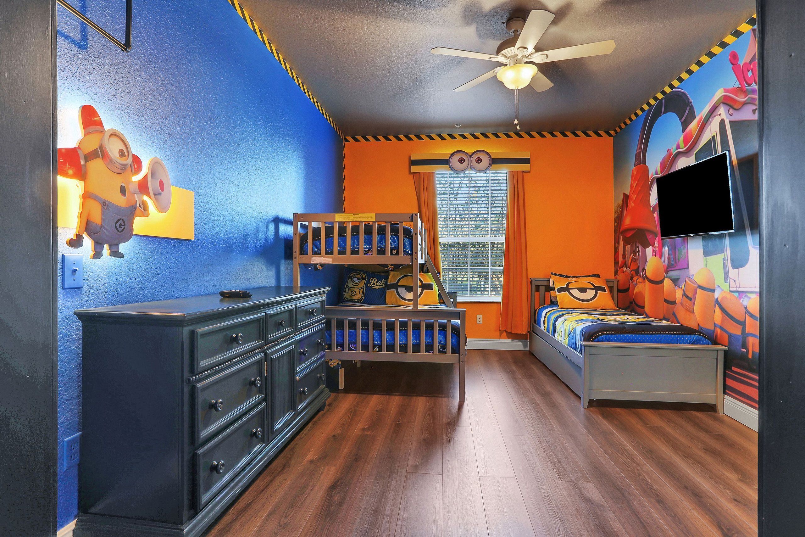 A child's bedroom with bunk beds, a dresser, and a TV.