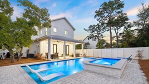 A two-story house with a swimming pool and patio furniture. - Modern Pet-Friendly Retreat for Families w/2 Bunk Rooms | Brand New Pool! (Seagrove Beach)