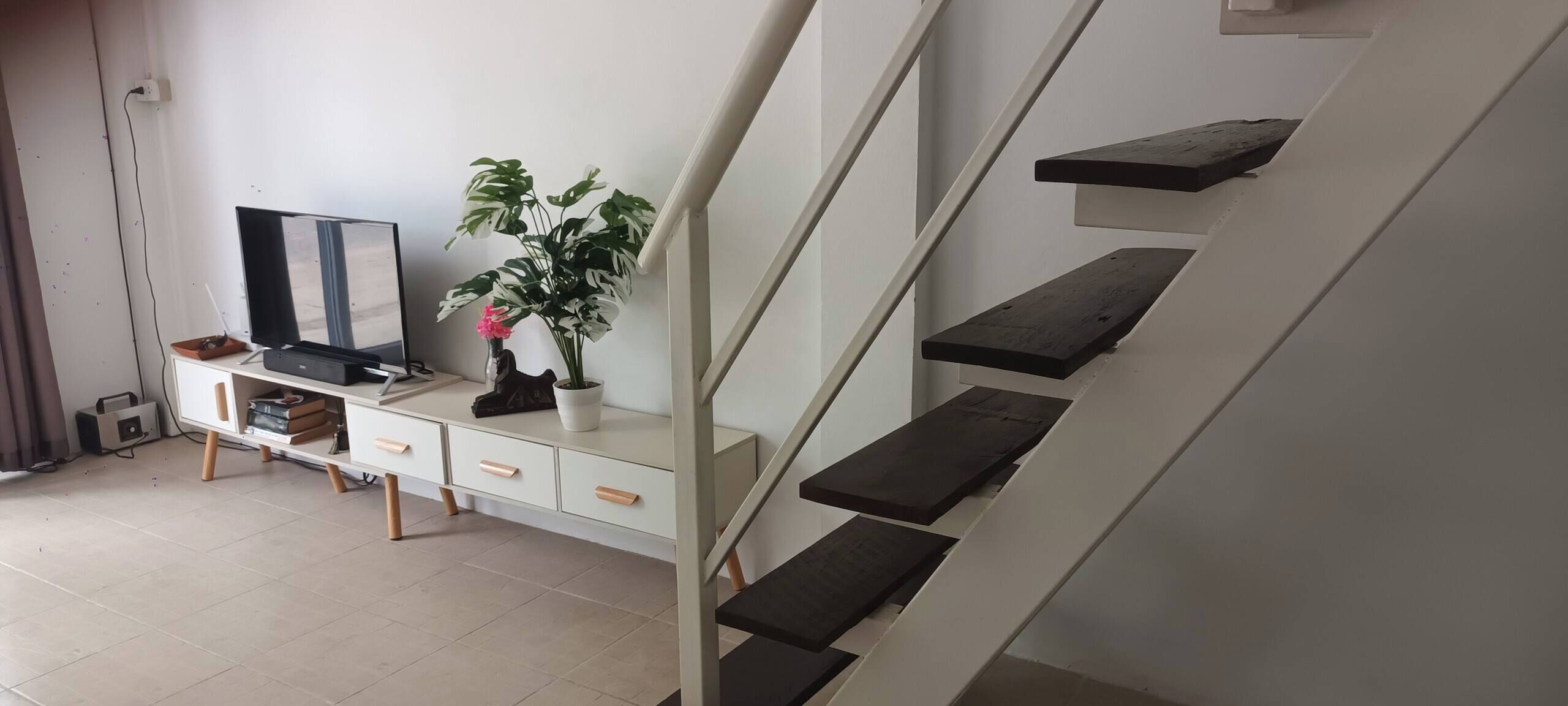 A staircase with wooden steps and a white wall.