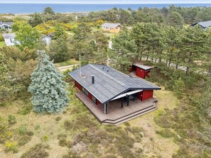 A modern house with a large deck, surrounded by trees and a view of the ocean. - "Sarita" - 200m from the sea by Interhome (Sjællands Odde)