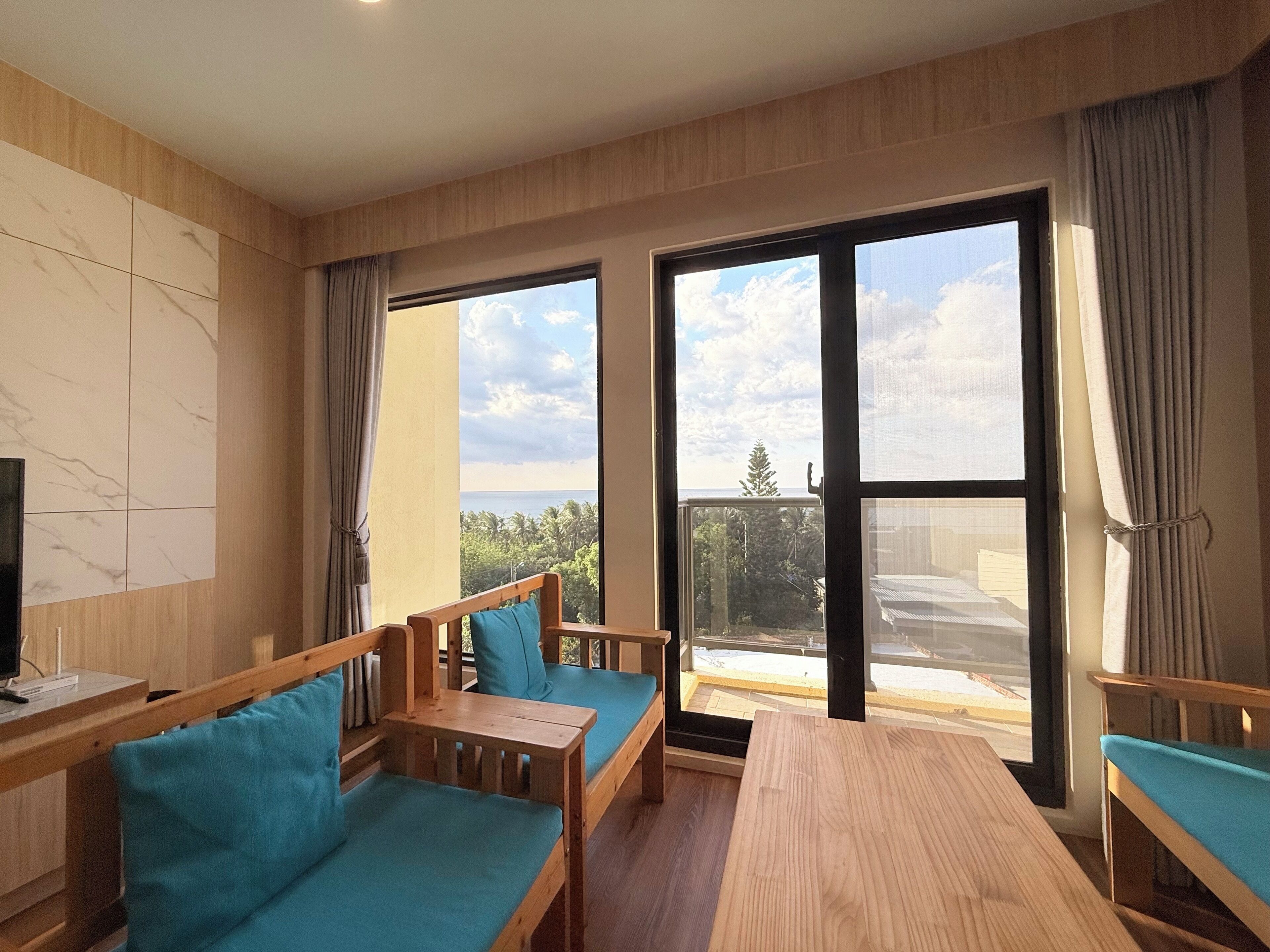 Exclusive Quadruple Room, Ocean View | Living area | 55-inch flat-screen TV with digital channels