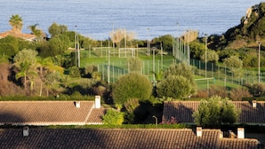 A coastal view with a golf course, residential buildings, and a clear sky. - Villa with pool 300 meters from the sea - Ogliastra (Tertenia)