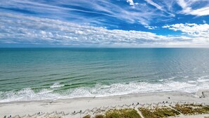 A beach with a clear sky, calm sea, and a sandy shore. - Palms Resort #1704: 2  BR, 2.5  BA Condominium in Myrtle Beach, Sleeps 6 (Myrtle Beach)