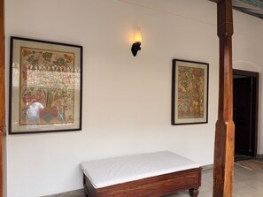 A room with a wooden bed, two framed artworks on the wall, and a wall-mounted light fixture. - VILLA KOBEIMALHÉNA, Matara
Spacious 3-bedroom colonial villa with private pool. (Sulthanagoda)