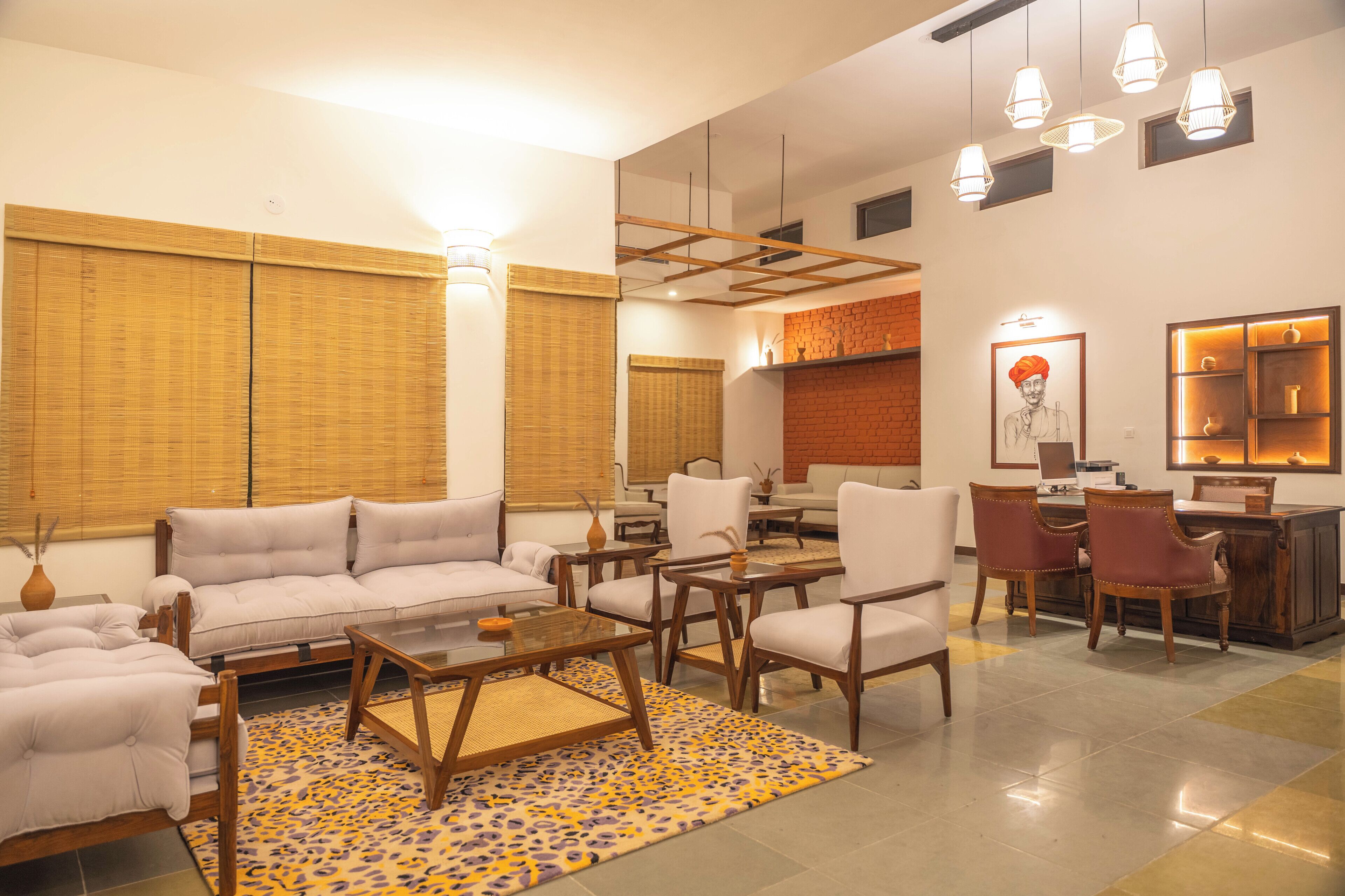 A spacious living area with sofas, a coffee table, and a desk with chairs.