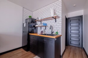 Fridge, microwave, coffee/tea maker, cookware/dishes/utensils